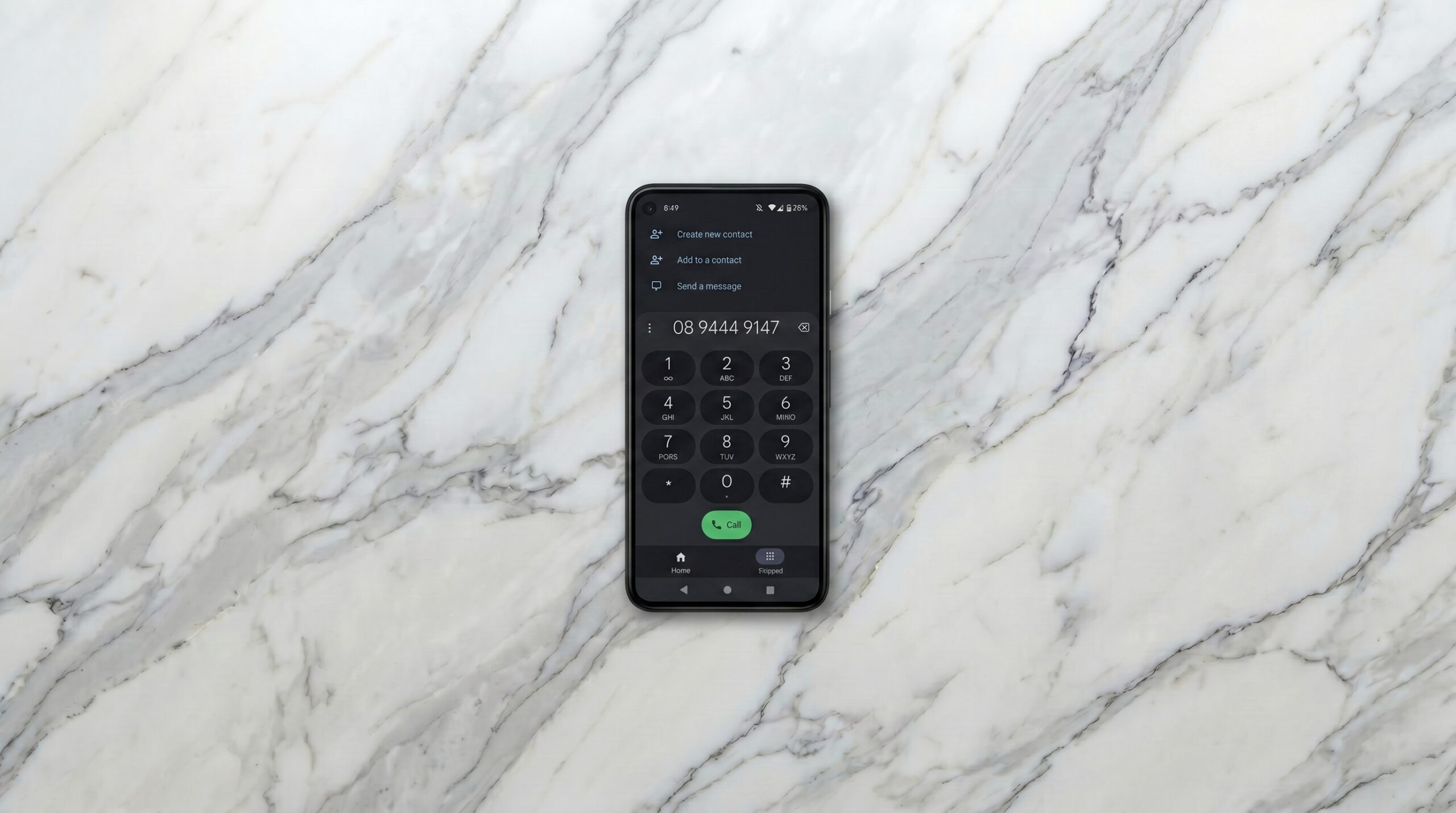 A phone with Focused Legal's number being dialed on a marble table